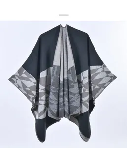 Close-up of geometric jacquard pattern on soft knit thick winter poncho for women