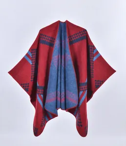 Close-up of geometric diamond pattern and stitched edges on knit poncho wrap