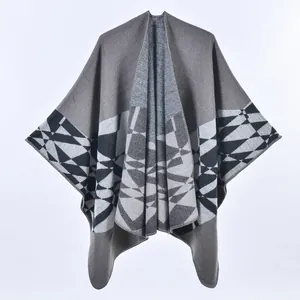 Detail of grey knitted shawl showing black and white geometric diamond patterns and texture