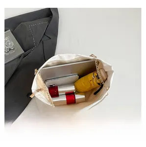 Interior view of beige commuter tote showing large capacity for laptop and daily essentials