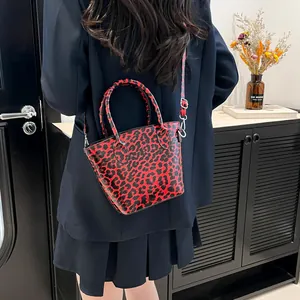 Fashionable red leopard print tote bag with top handles and adjustable shoulder strap