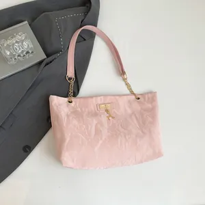 Pink pleated nylon shoulder bag with golden chain strap and cute deer pendant detail