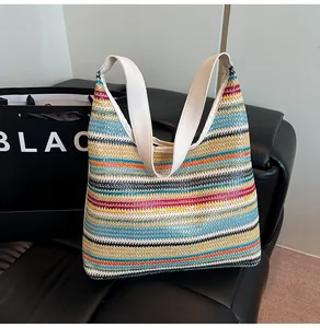 Detailed macro view of multi-color woven straw tote bag texture and reinforced wide strap