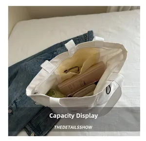 Internal view of a large white canvas tote bag showing storage capacity and zipper pocket