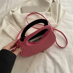 Pink striped leather mini handbag with top handle and crossbody strap for women