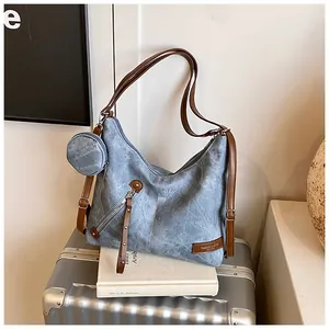 Close-up of vintage blue tote with brown leather straps and small round coin purse