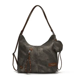 Large gray canvas tote bag with brown leather straps and a matching small round pouch