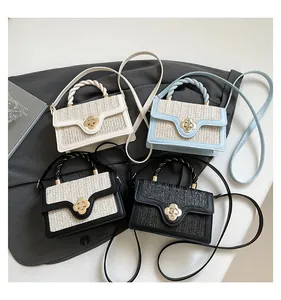 Macro detail of four straw patchwork handbags with clover metal clasps and woven handles