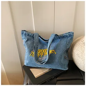 Close-up of vintage blue denim tote bag with Groovy Happy Heart embroidery details