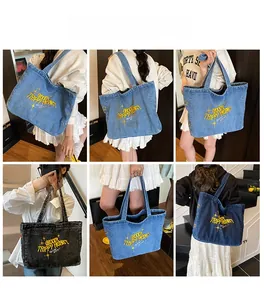 Close-up of Large denim tote bag featuring yellow Groovy Trippy Heart embroidery detail