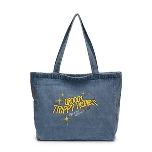 Retro denim tote bag with yellow embroidery text and star patterns on white background
