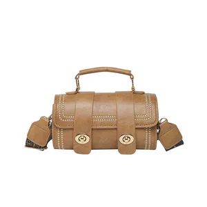 Brown vintage cylinder crossbody bag with bead accents and bohemian wide shoulder strap