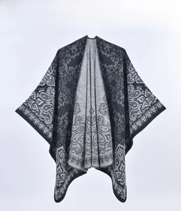 Close-up of retro paisley pattern on thick knit cashmere-like winter poncho shawl