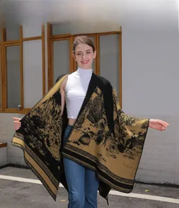 Detail shot of a thick mustard yellow and black knit shawl featuring artistic landscape patterns