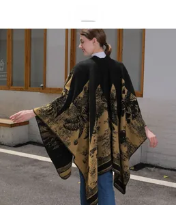 Detail of knit shawl poncho featuring tropical palm patterns and striped tassel edges