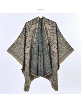 Detail of vintage paisley pattern on a thick reversible knit shawl with edge stitching