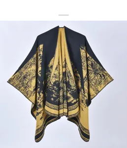 Detailed view of the thick knit texture and tropical palm leaf pattern on the poncho