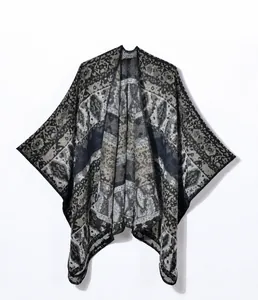 Detailed view of geometric folk pattern and knit texture on this vintage shawl poncho