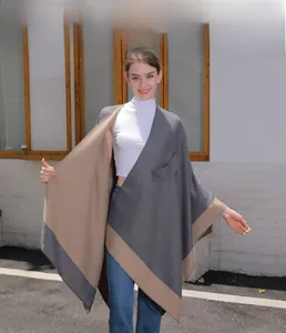 Detail of grey and beige reversible knit shawl featuring large side pockets for women