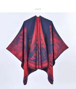 Close-up of knit shawl showing red and navy tropical palm tree landscape pattern