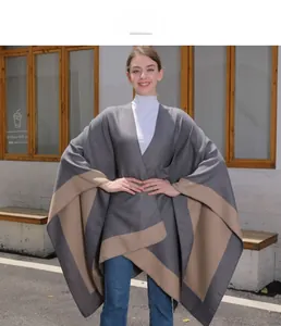 Detail of grey and camel cashmere-feel poncho with split-front and draped silhouette