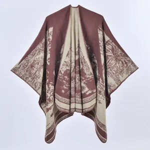 Detail showing jacquard knit landscape pattern on thick brown and beige poncho shawl