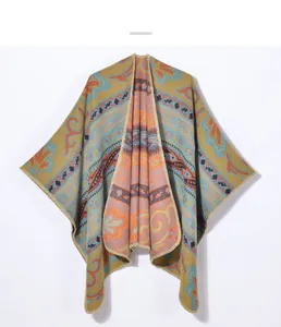 Close-up of ginger knitted poncho with ethnic paisley patterns and woven textures