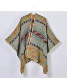 Close-up of bohemian knit shawl featuring ethnic geometric patterns in mustard yellow