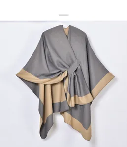 Close-up of knit fabric texture and color-block hem on the women shawl poncho