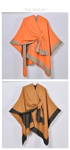 Close-up of dual-color knit ponchos with front tie detail in orange and camel hues
