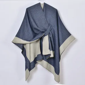 Detail of the high-quality woven texture on a navy and grey split-front shawl cape
