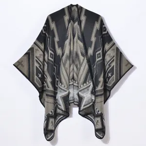 Thick geometric jacquard knitted poncho cape with tribal patterns in black and brown