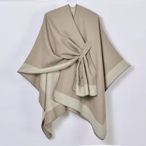 Close-up of khaki cashmere-feel shawl featuring contrast trim and front knot design