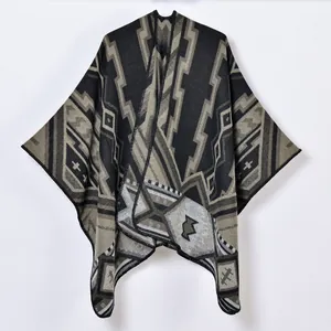Thick knit poncho shawl with geometric Aztec pattern and elegant black stitching
