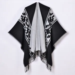 Elegant black and white geometric knit shawl with tassel hem for a stylish outer layer