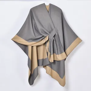 Women's knit poncho wrap with gray and brown contrast panels and front lace-up closure