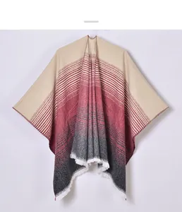 Detail of knit shawl featuring tricolor gradient stripes and elegant white fringe hem