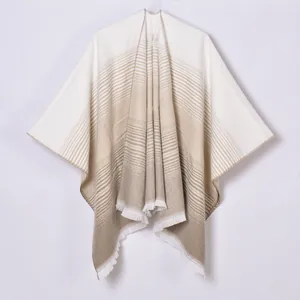 Detail view of the fine fringe hem and gradient stripe pattern on the pashmina shawl