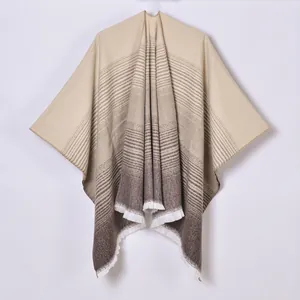 Women's gradient cashmere-like poncho wrap with fringe trim in a minimalist striped design