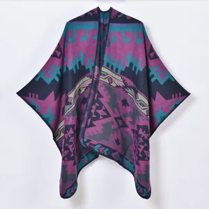 Detailed knit texture of ethnic geometric pattern shawl with fringe and split front