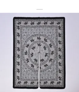 Detail of retro ethnic knit shawl with elephant jacquard patterns and split poncho hem