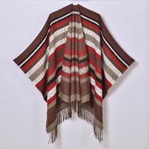 Vintage bohemian style fringe poncho with geometric patterns in warm brown tones