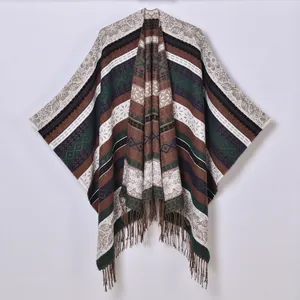 Detail of bohemian knit shawl featuring ethnic geometric patterns and long fringe tassels