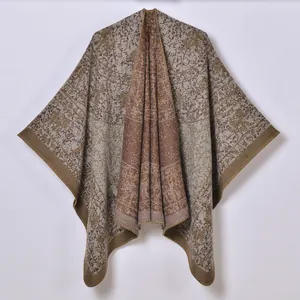 Close-up of thick jacquard knit poncho with brown retro ethnic patterns and stitching