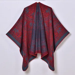 Detailed close-up of ethnic jacquard pattern with elephants on warm knitted poncho shawl