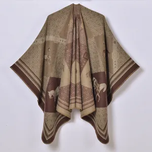 Close-up of thick knit shawl fabric featuring horse patterns and geometric textures