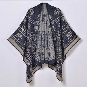 Ethnic knit poncho featuring navy blue elephant patterns and bohemian geometric textures