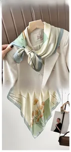 Détail d'un carré de soie avec imprimé feuilles de ginkgo en vert sauge et crème