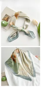 Détail d'un foulard en soie à motif ginkgo porté sur un col de chemise blanc