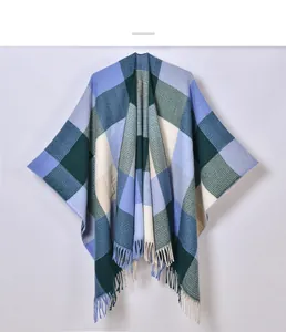 Macro detail of classic plaid shawl featuring knit texture and fringe hem in cool tones